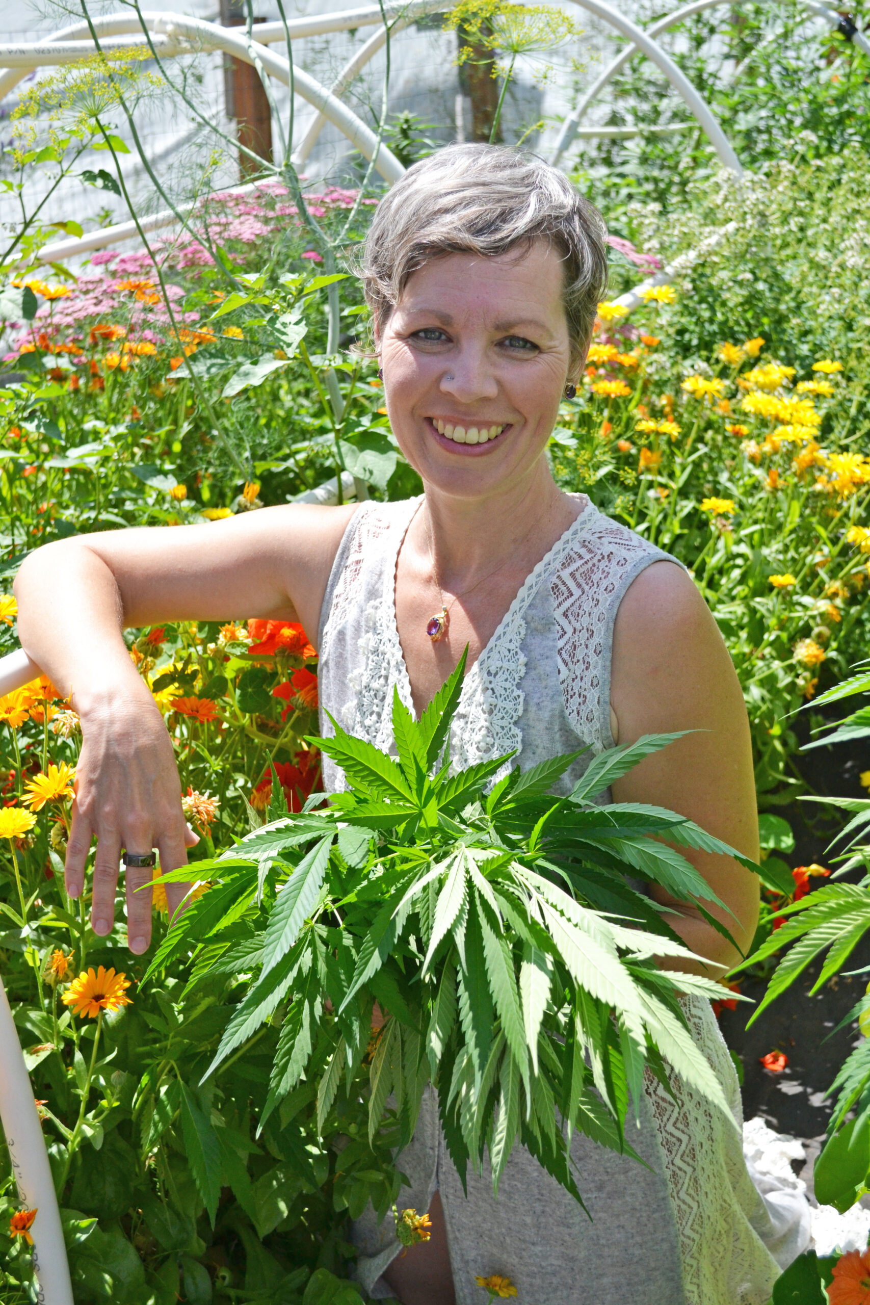 cannabis coach in the cannabis garden holding cannabis plants